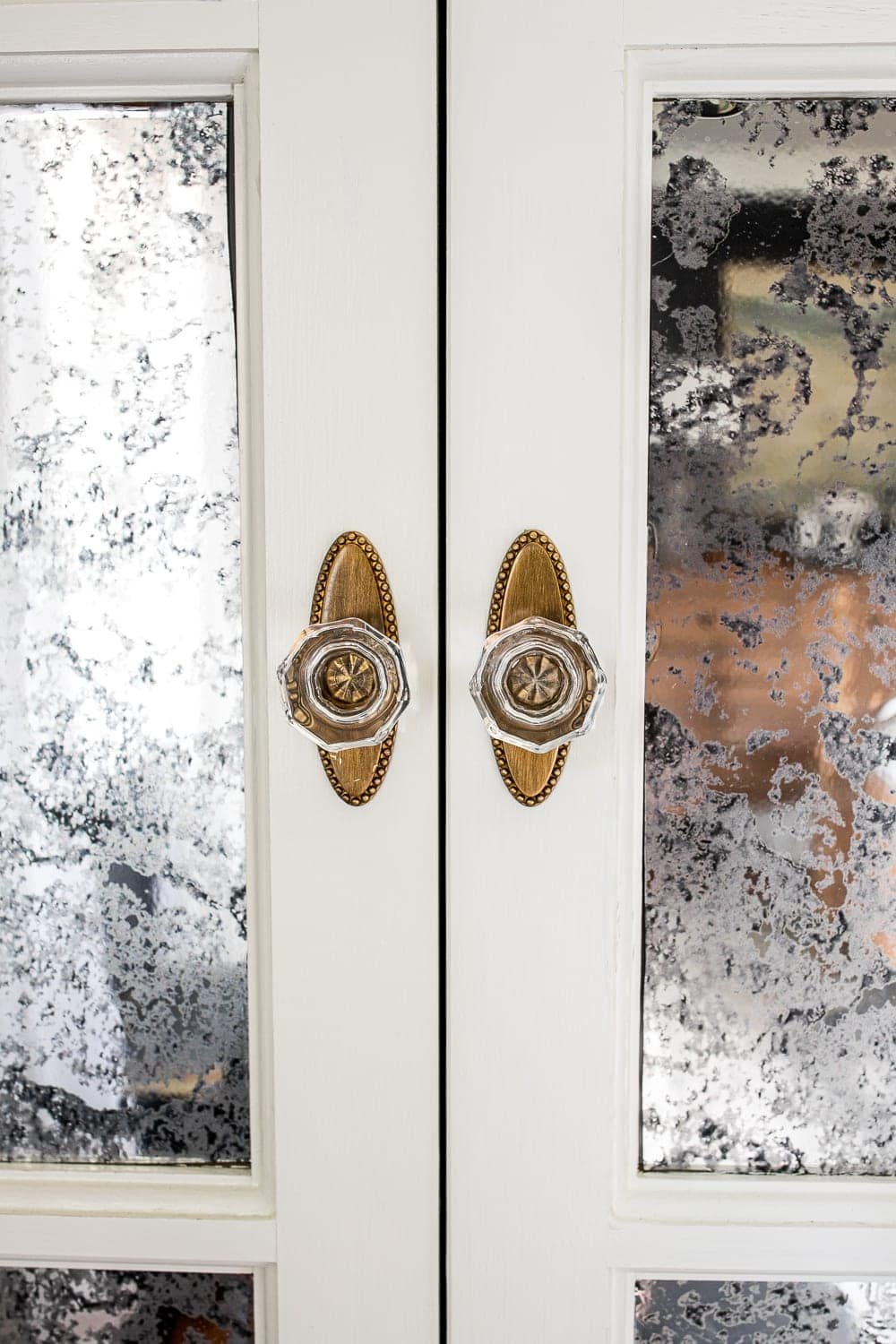 glass cabinet knobs with antique brass backplate on bifold doors