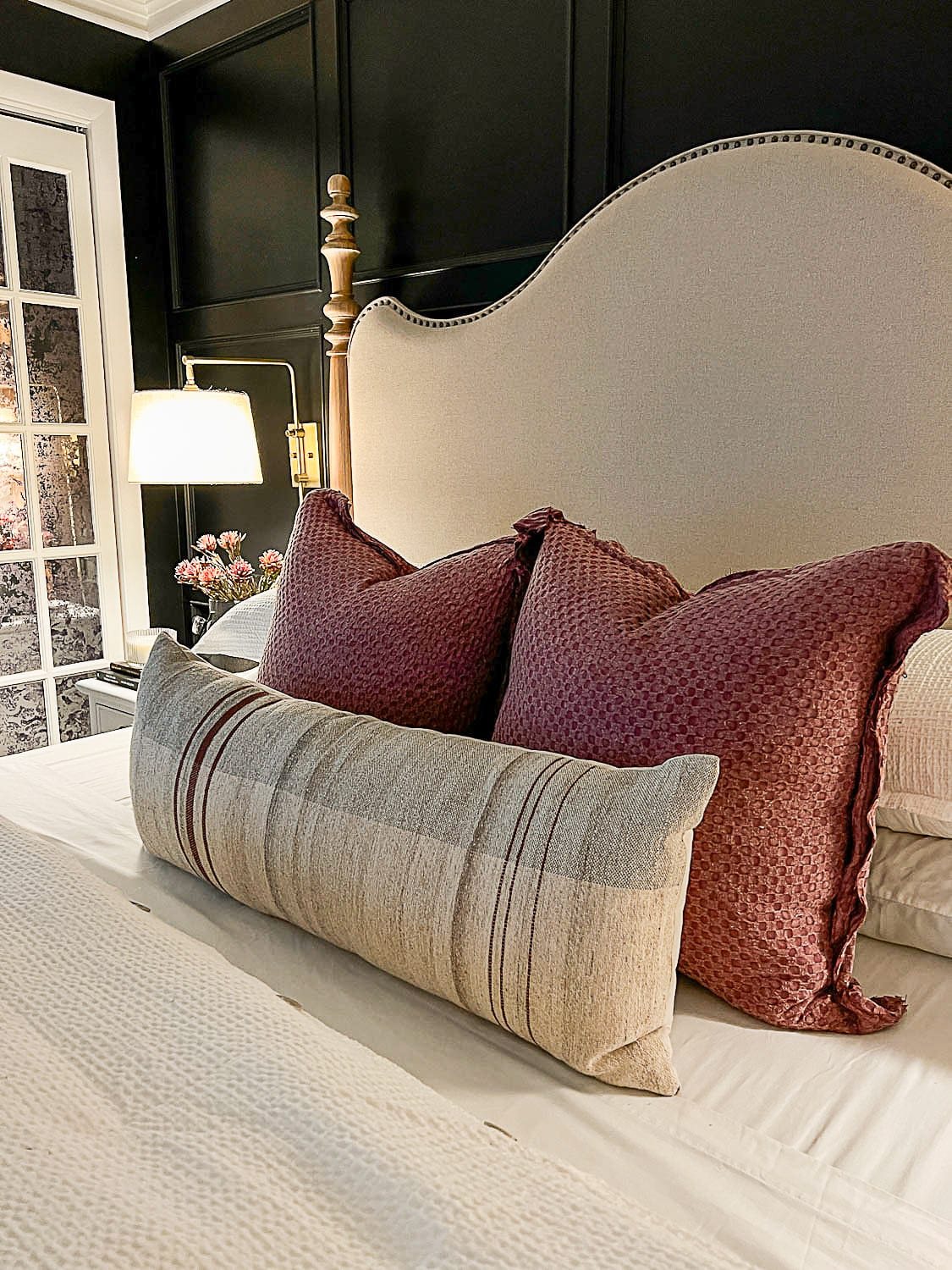 fall pillows on bed with lamp light
