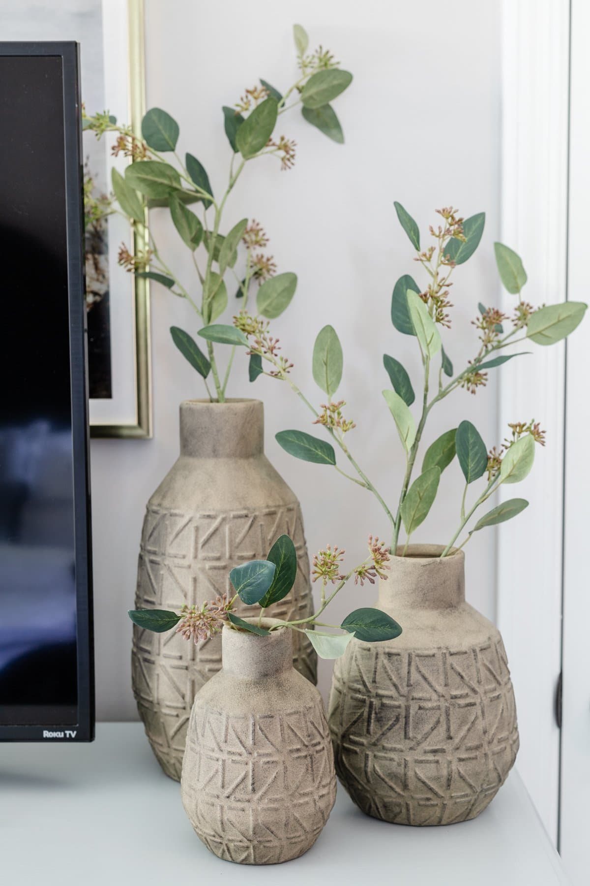 3 vases with stems on dresser decor in bedroom