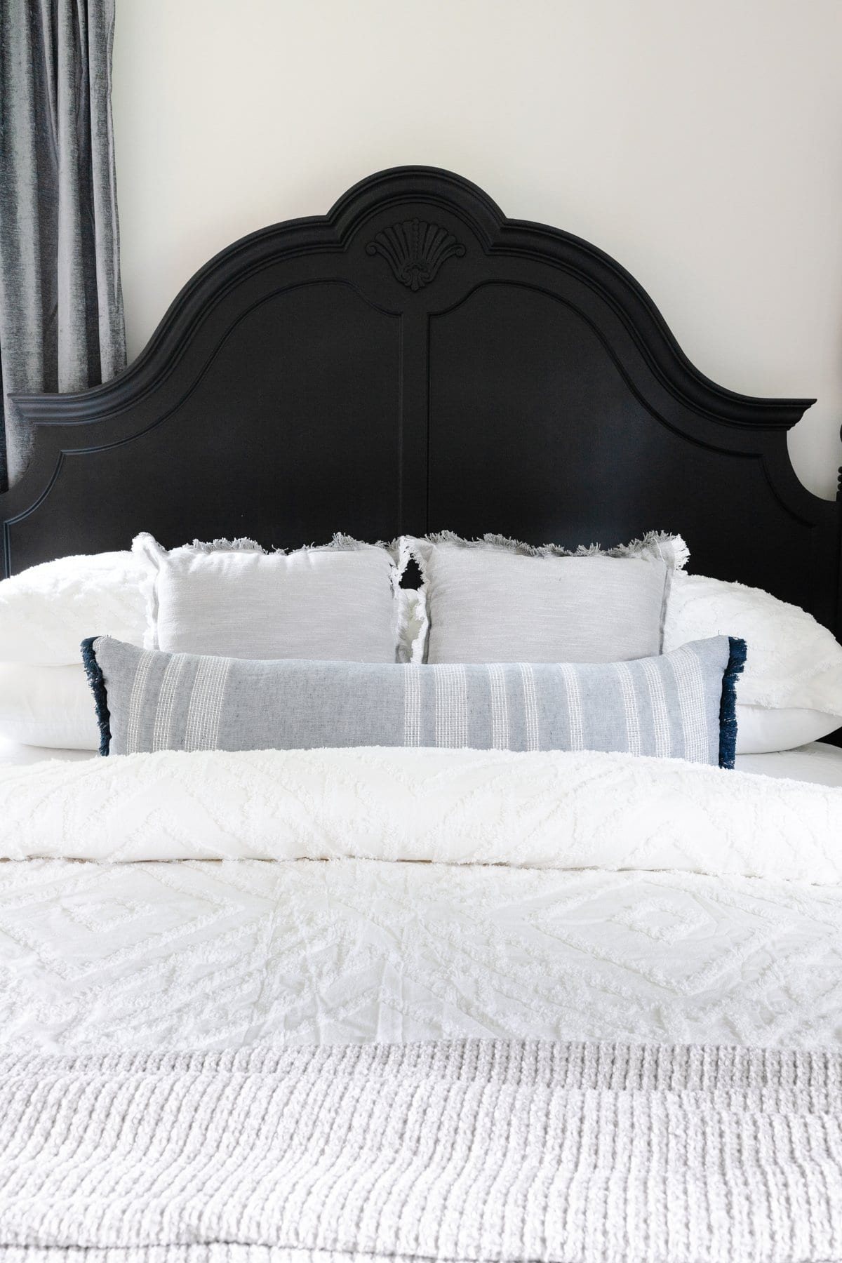 black painted poster bed with white bedding