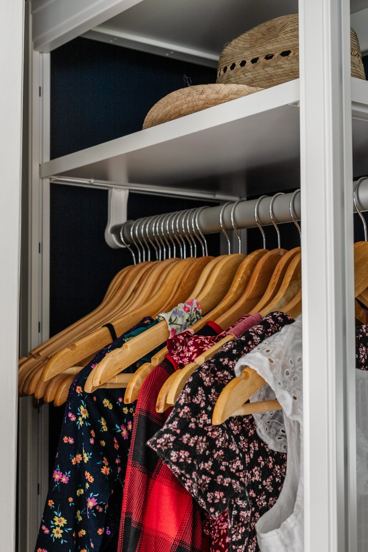 matching wooden hangers on a rod to minimize clutter