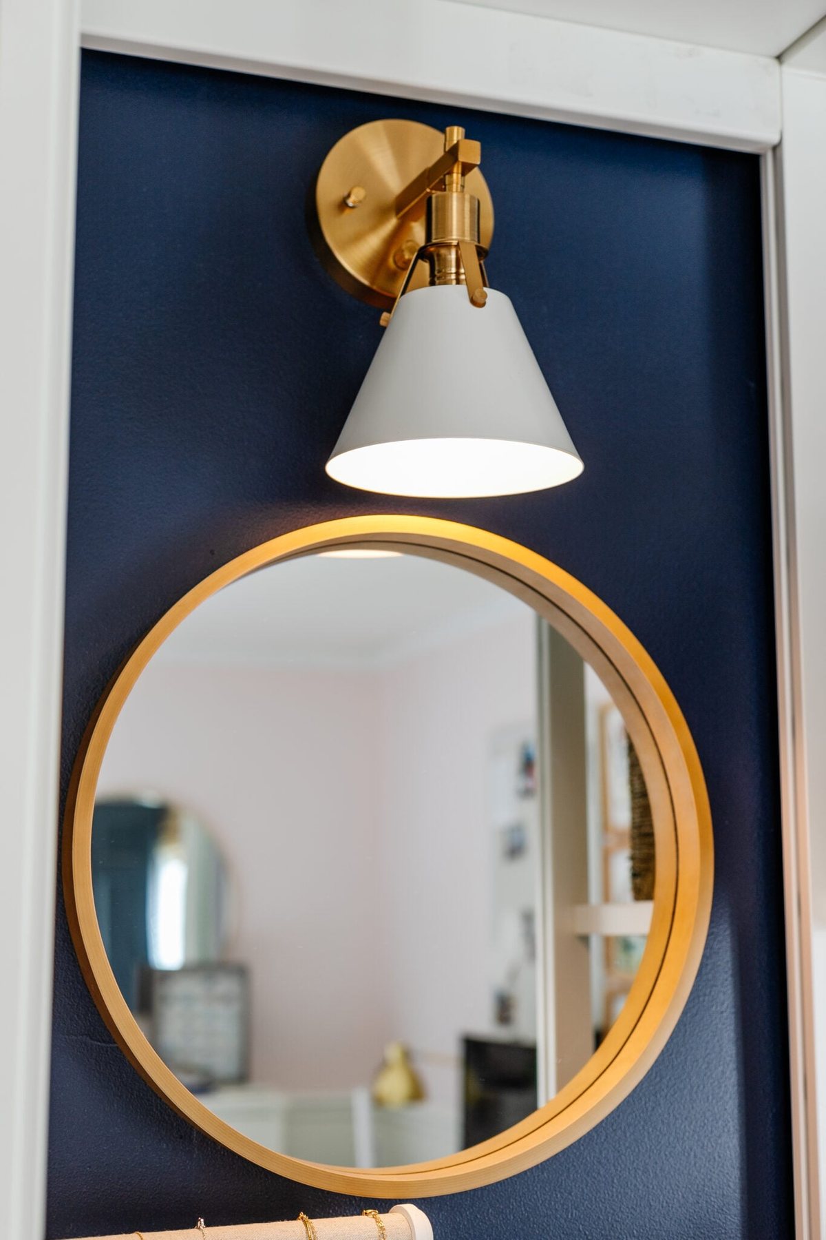 closet lighting using a sconce with battery puck light over a mirror
