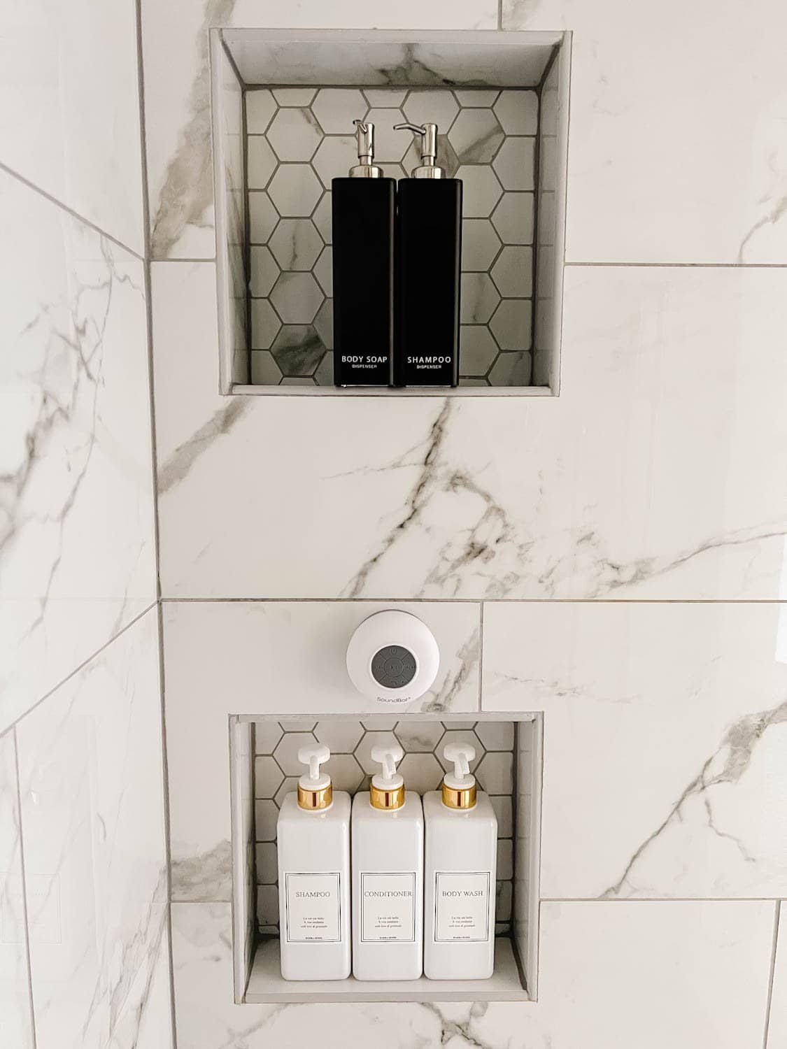 shower dispenser set in shower niche with waterproof bluetooth speaker