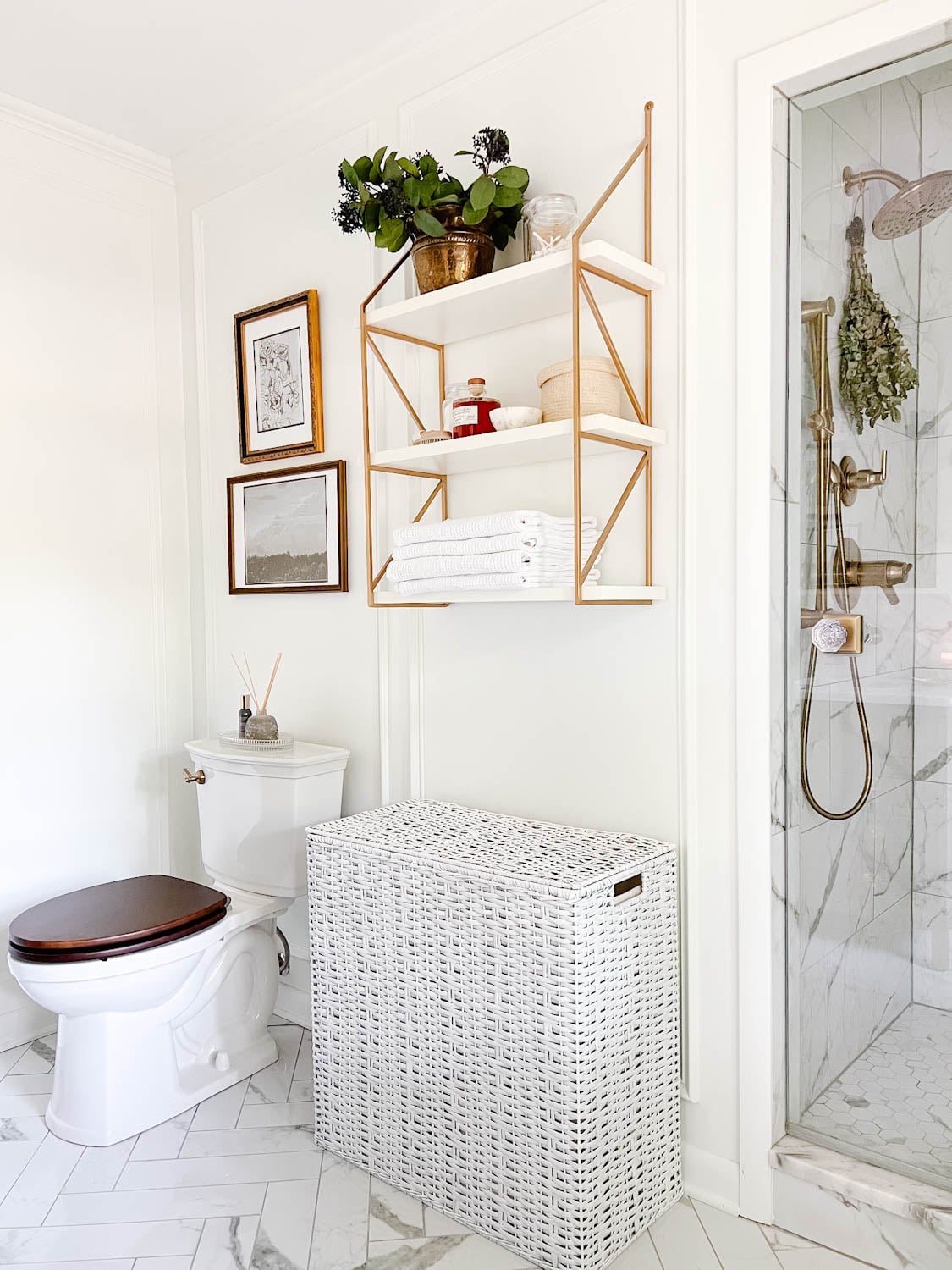 spa bathroom shelf with apothecary jars, eucalyptus from the shower head, and waffle weave towels