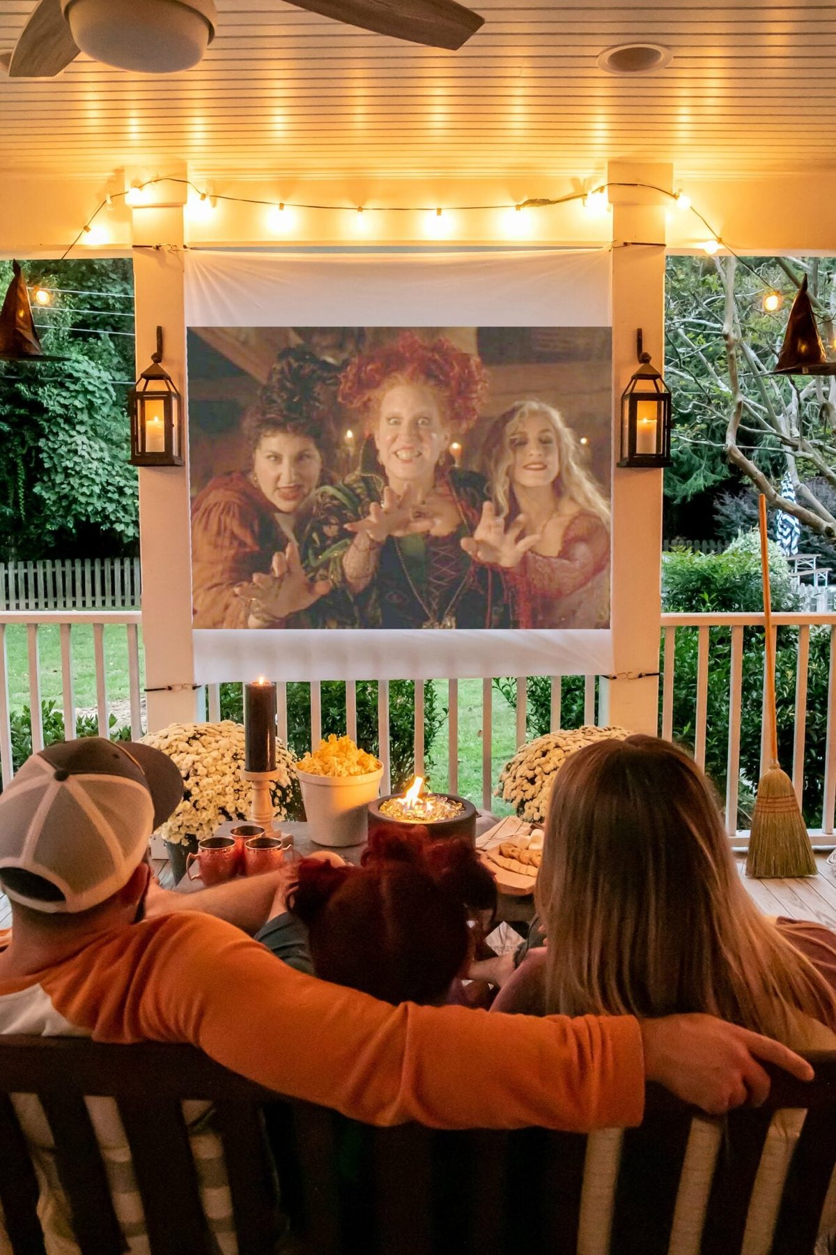 outdoor movie on back porch with fall decor