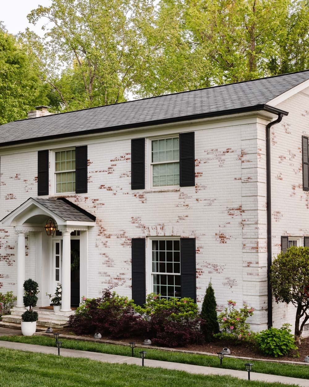 limewashed brick colonial with solar lights