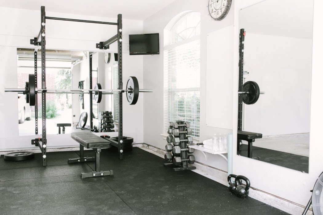 home gym with padded floor and weights