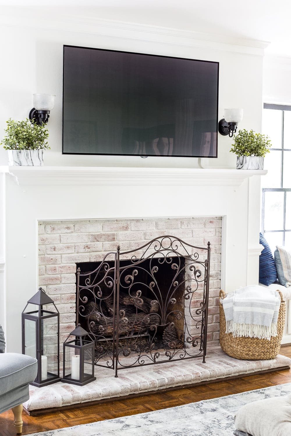 limewashed brick fireplace with tv above mantel