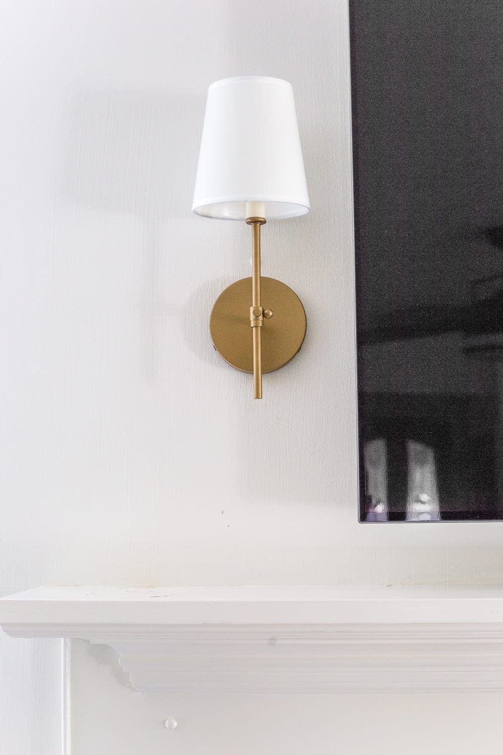 Keep your mantel simple with just a pair of sconces on either side of your TV.
