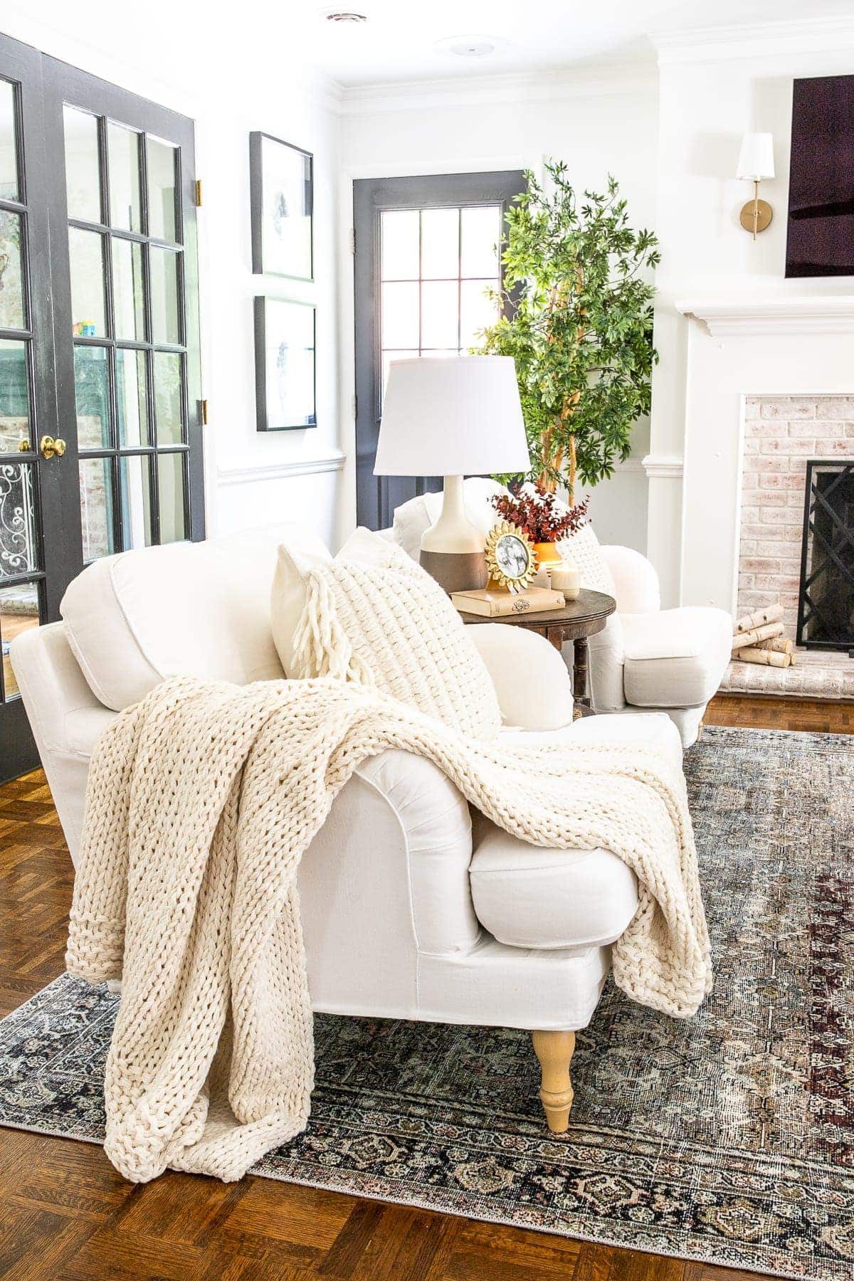 living room accent chairs with cable knit throw blanket and pillows