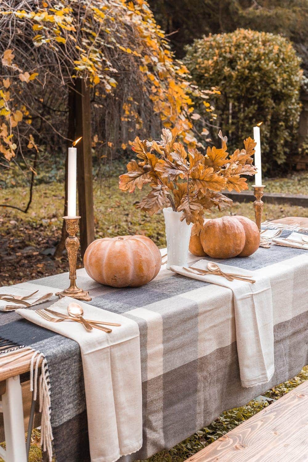 throw blanket used as a tablecloth for fall decor