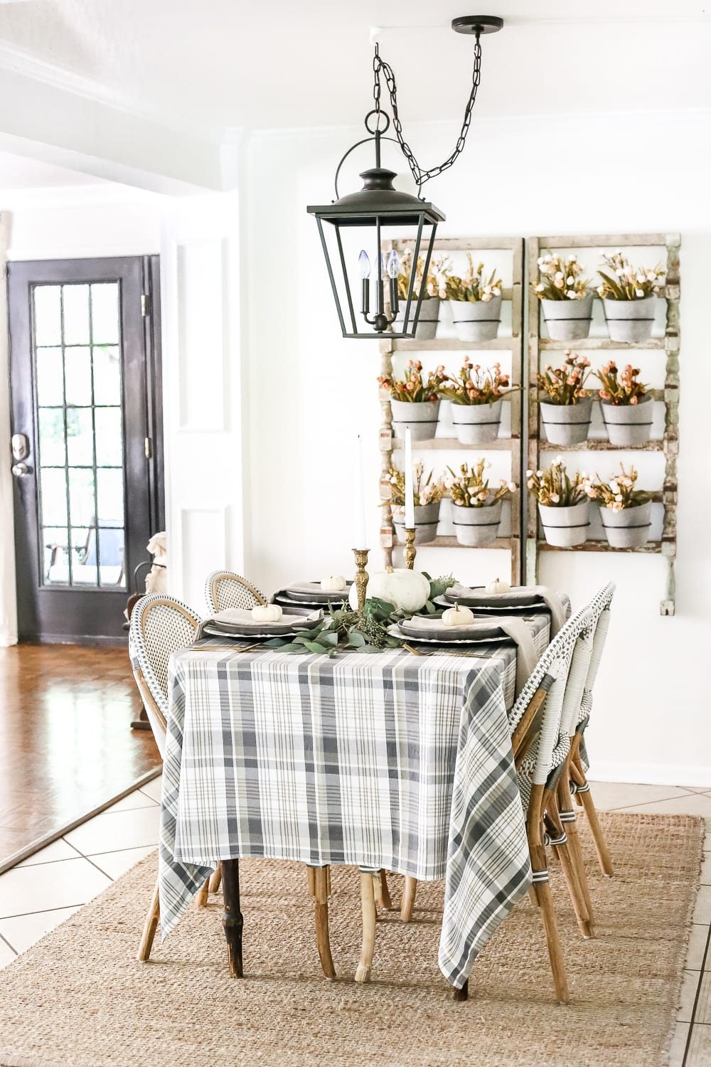 Neutral Low-Key Thanksgiving Tablescape | unigumushane.com - A neutral low-key Thanksgiving tablescape that is simple and inexpensive to recreate using plaid fabric, white pumpkins, eucalyptus, and brass.