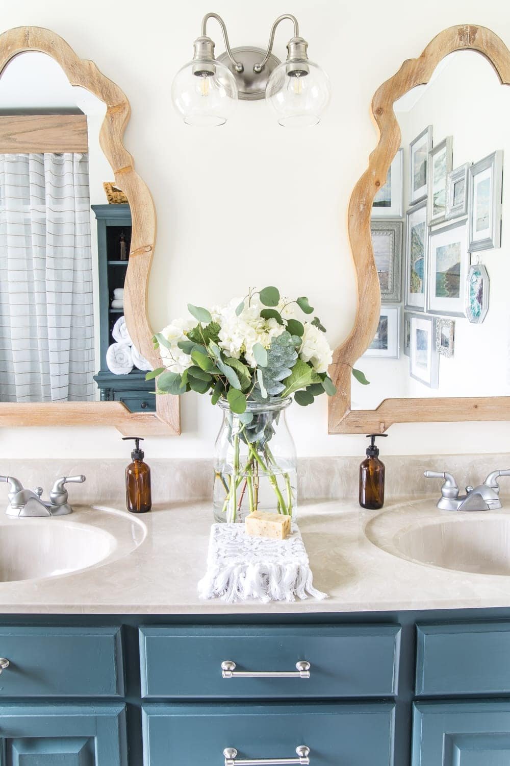 Budget Master Bathroom Refresh Reveal | Vinyl hexagon tile floor, wooden arch mirrors, and DIY painted vanity