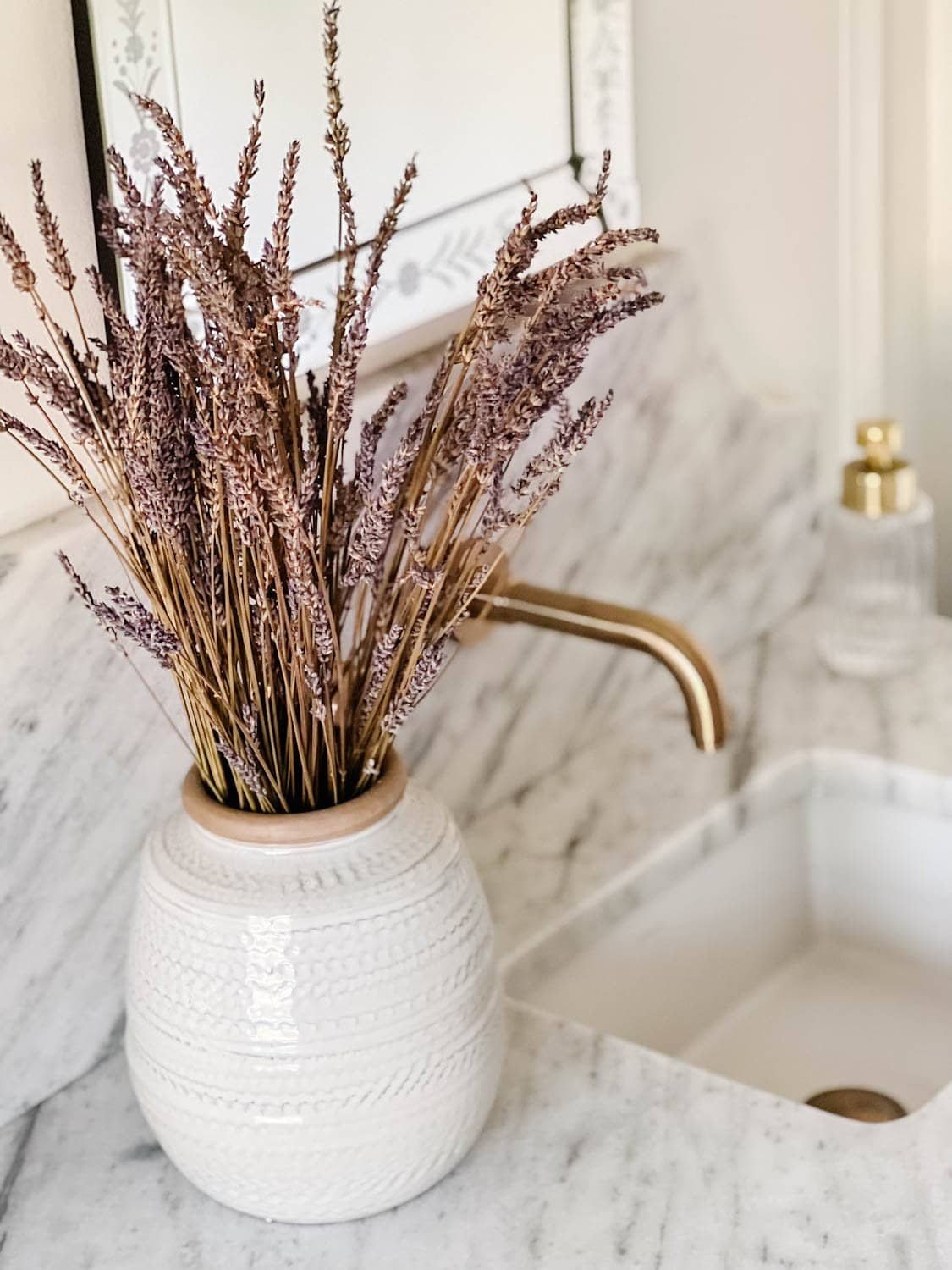 dried lavender in a vase on a bathroom countertop