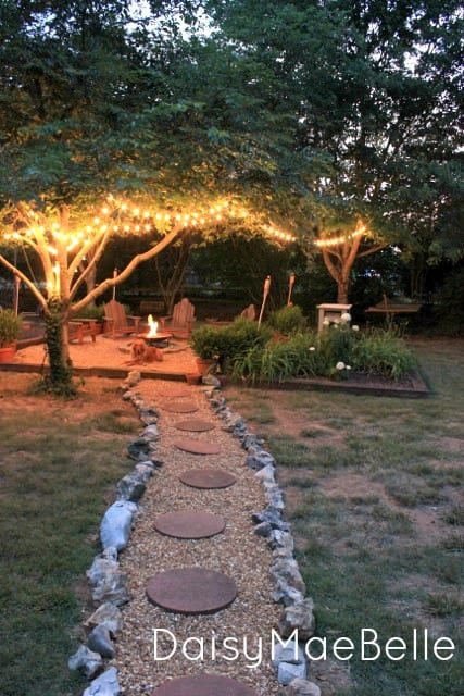 fire pit with string lights in trees