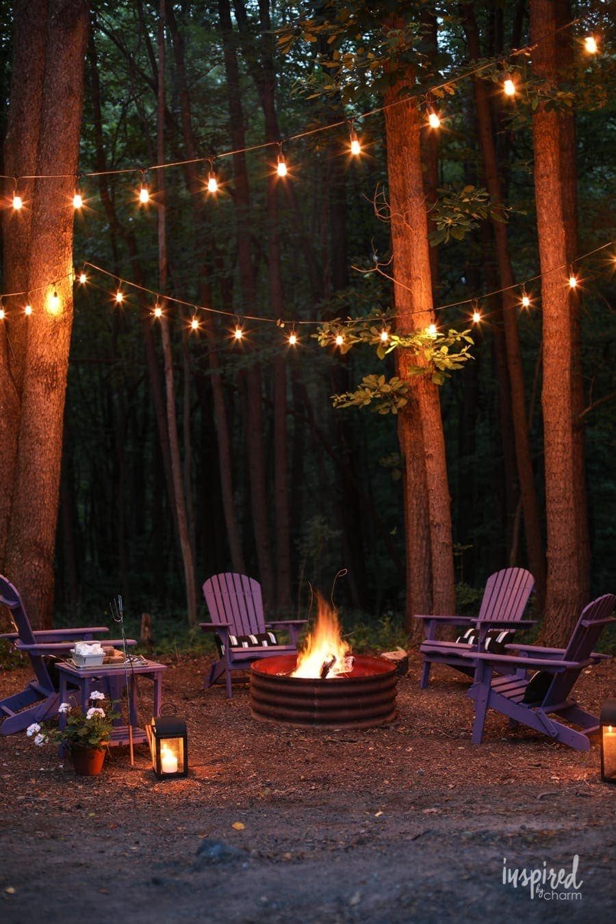 simple fire pit with string lights in trees