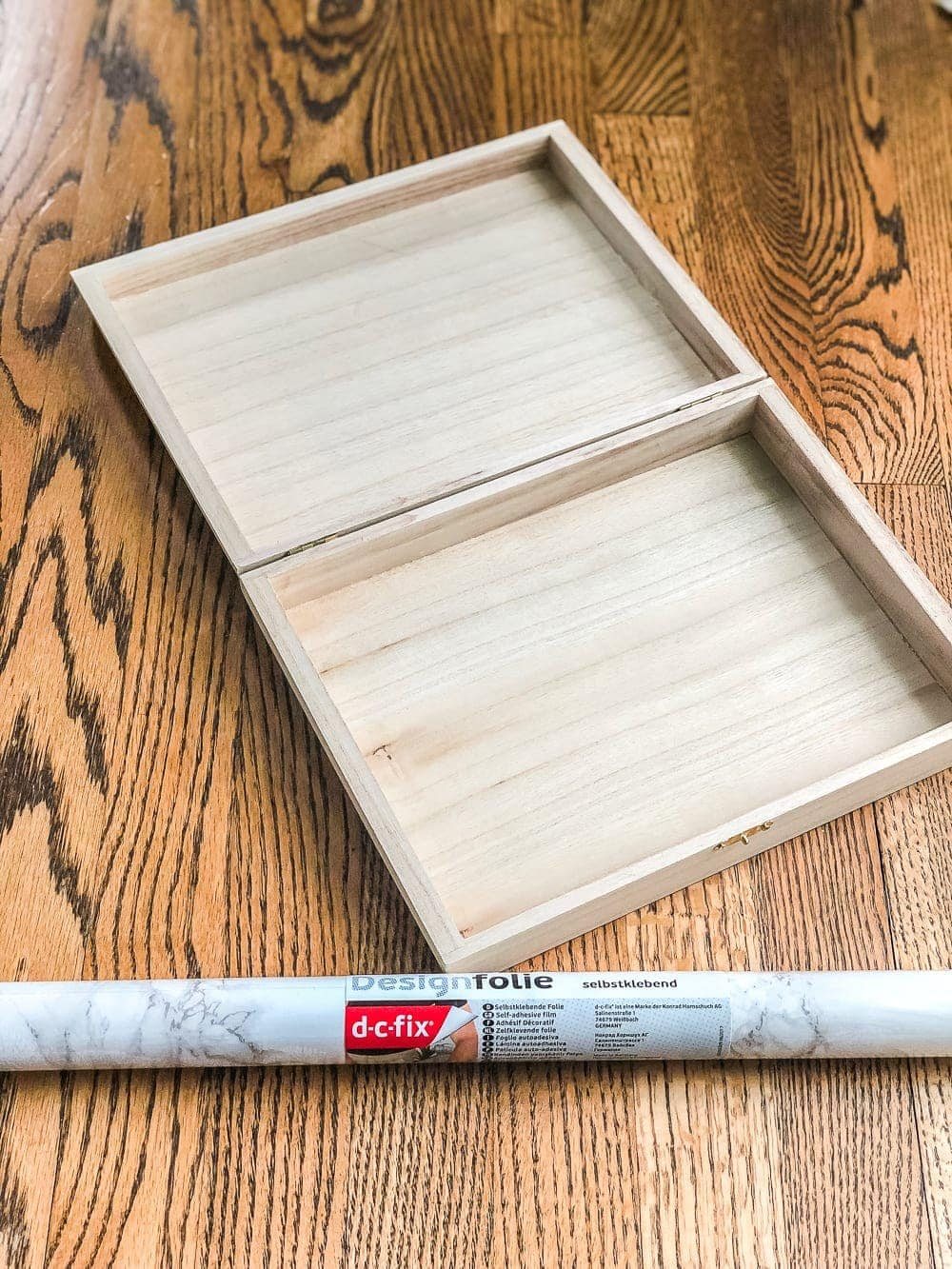 How to wrap a cigar box with contact paper to repurpose into a decorative remote control holder for a coffee table. #remotecontrolholder #coffeetabledecor