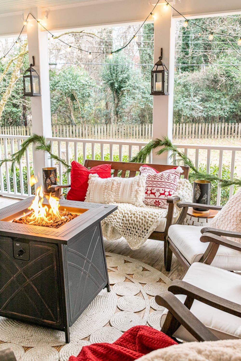 Cozy Christmas back porch with traditional red and green colors and cozy throw pillows and blankets