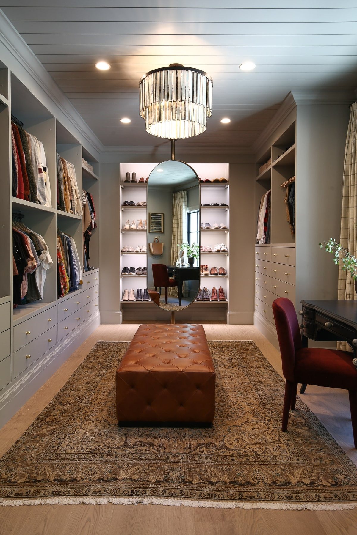 modern traditional master closet with mirror stand and vanity