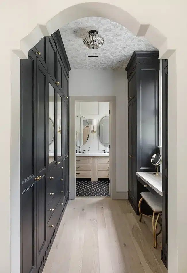 Black IKEA PAX wardrobes with doors and vanity in a primary en suite