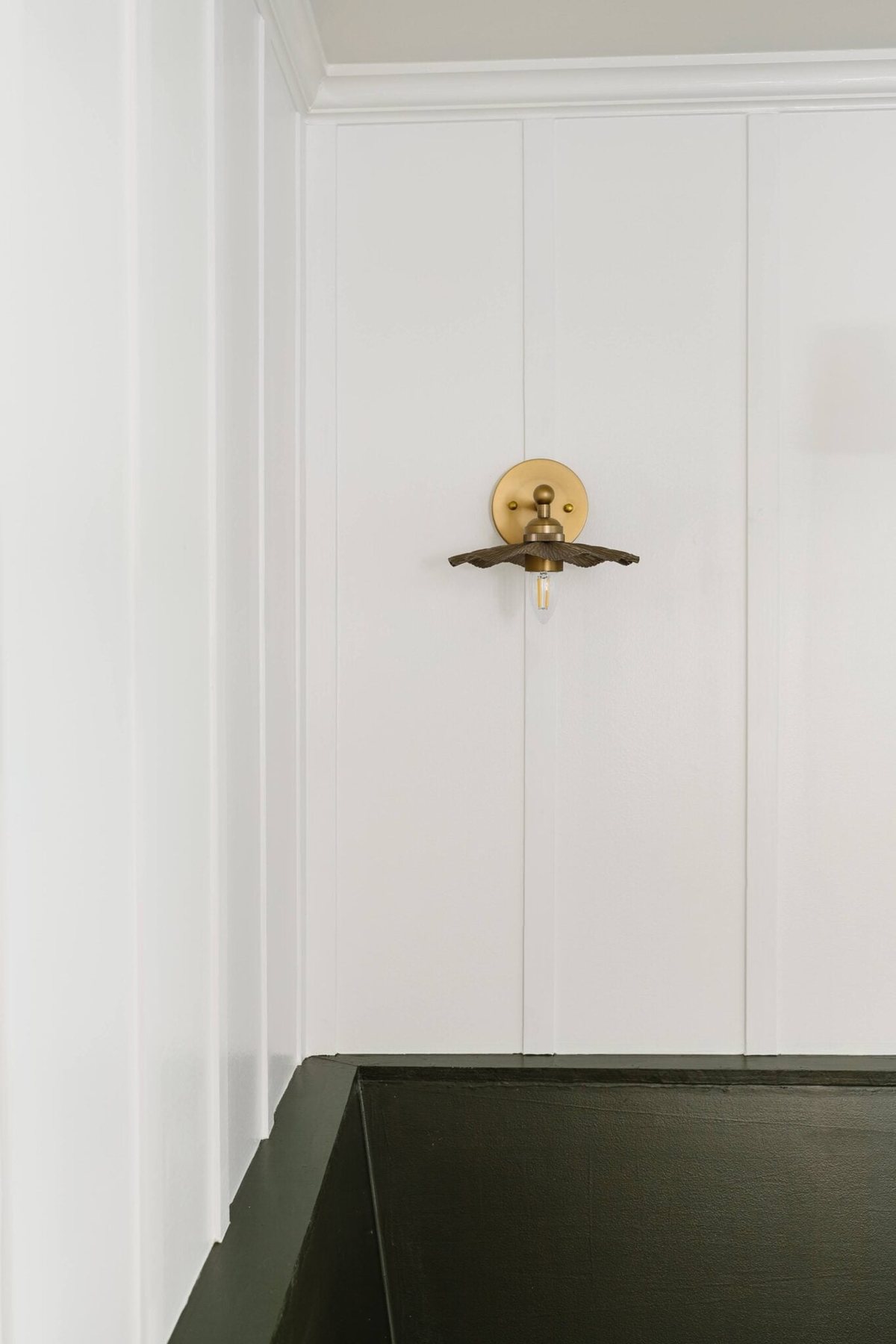 ruffled flower vintage brass wall lights on a board and batten wall