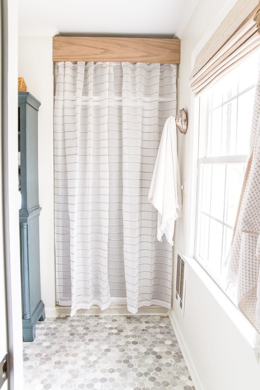 Budget Master Bathroom Refresh Reveal | old shower door cover-up with a semi-sheer curtain and a DIY wooden cornice