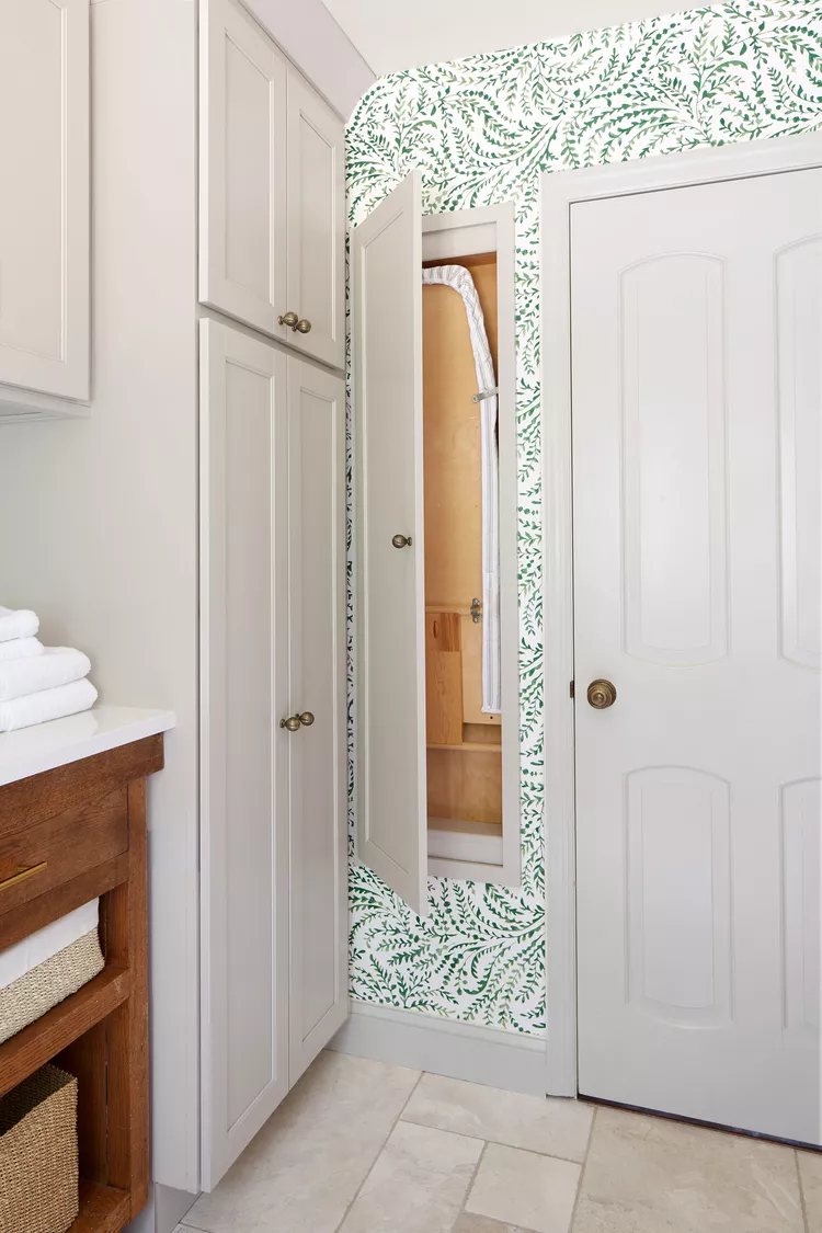 Hidden ironing board cupboard in between wall studs