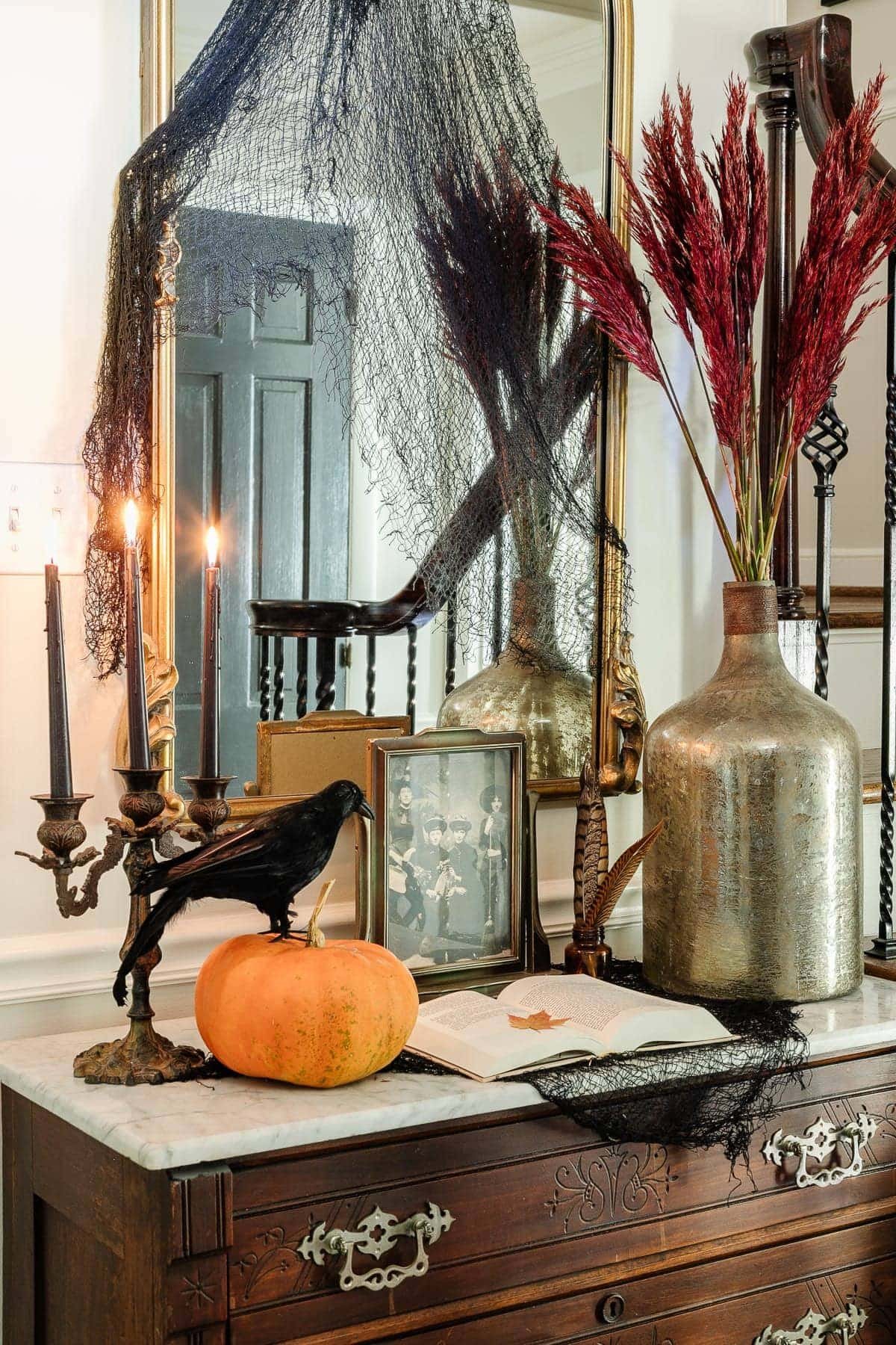 entry table with vintage Halloween decor for a spooky elegant style vignette