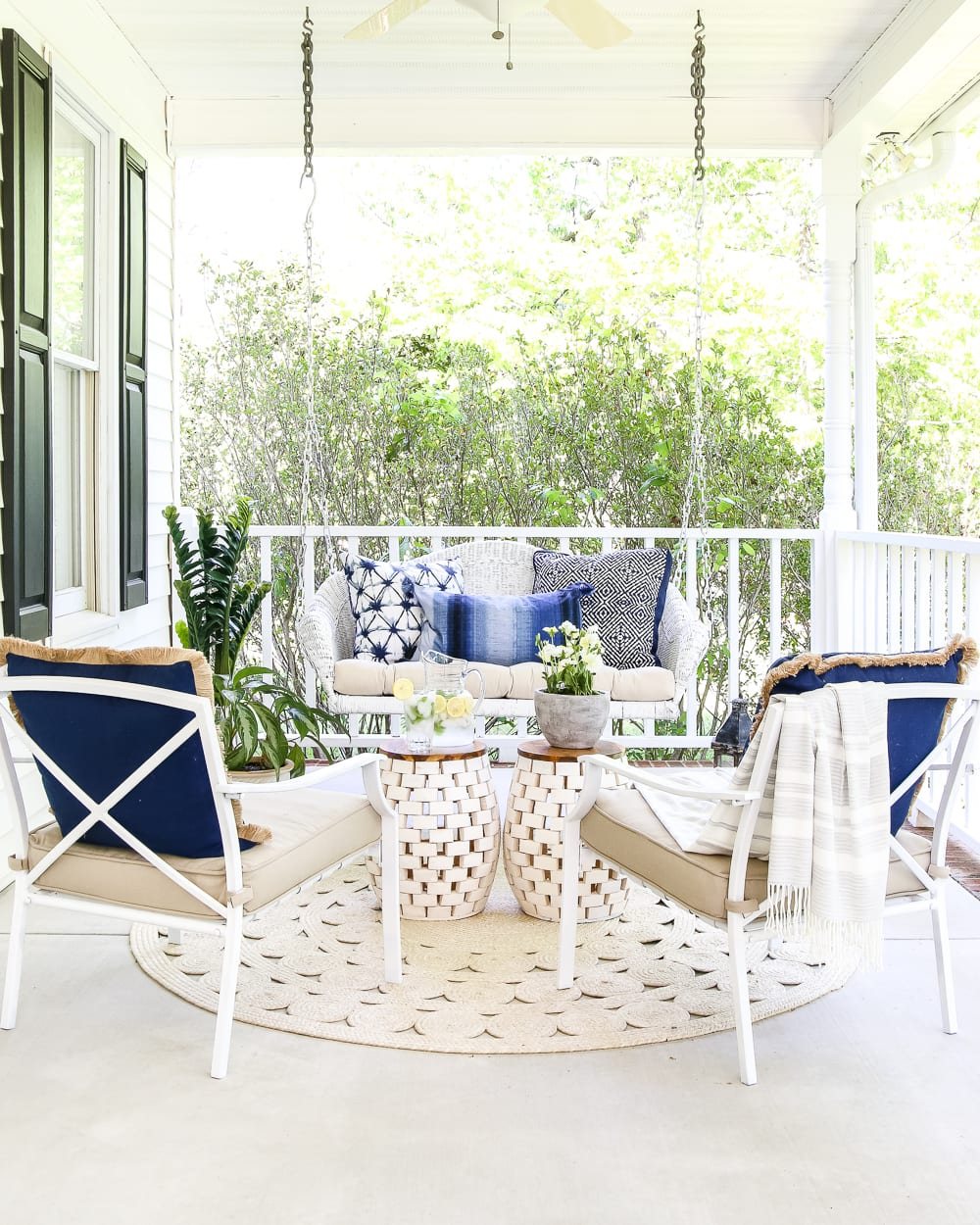 swing and chairs in a conversation area on a porch