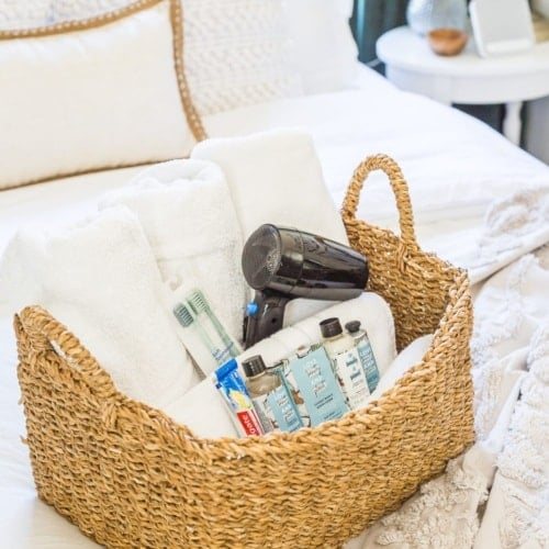 38 Guest Bedroom Essentials | Have a basket with extra towels and extra toiletries in case guests forget any.