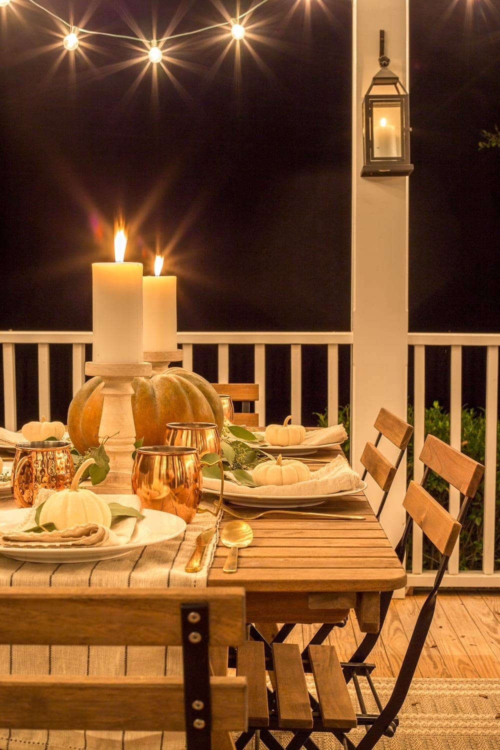 Fall Back Porch at Night | How to style your outdoor spaces for autumn using capsule decor items that will last throughout the seasons and get the most bang for your buck.