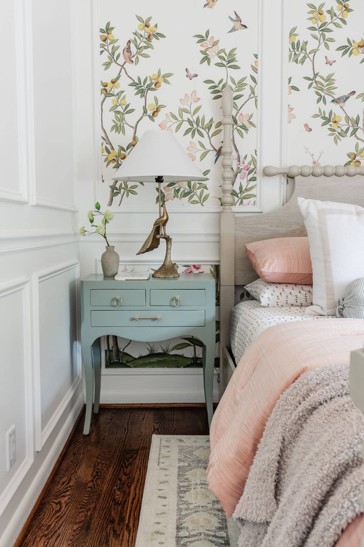 peacock table lamp on a gloss painted bedside table in a little girl's bedroom