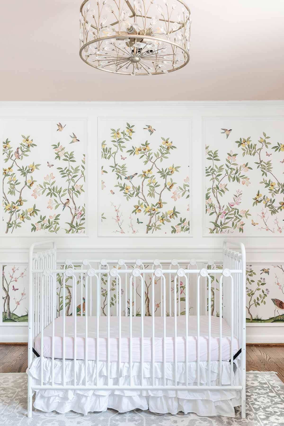 chinoiserie wallpaper inside picture frame molding in a girl's room