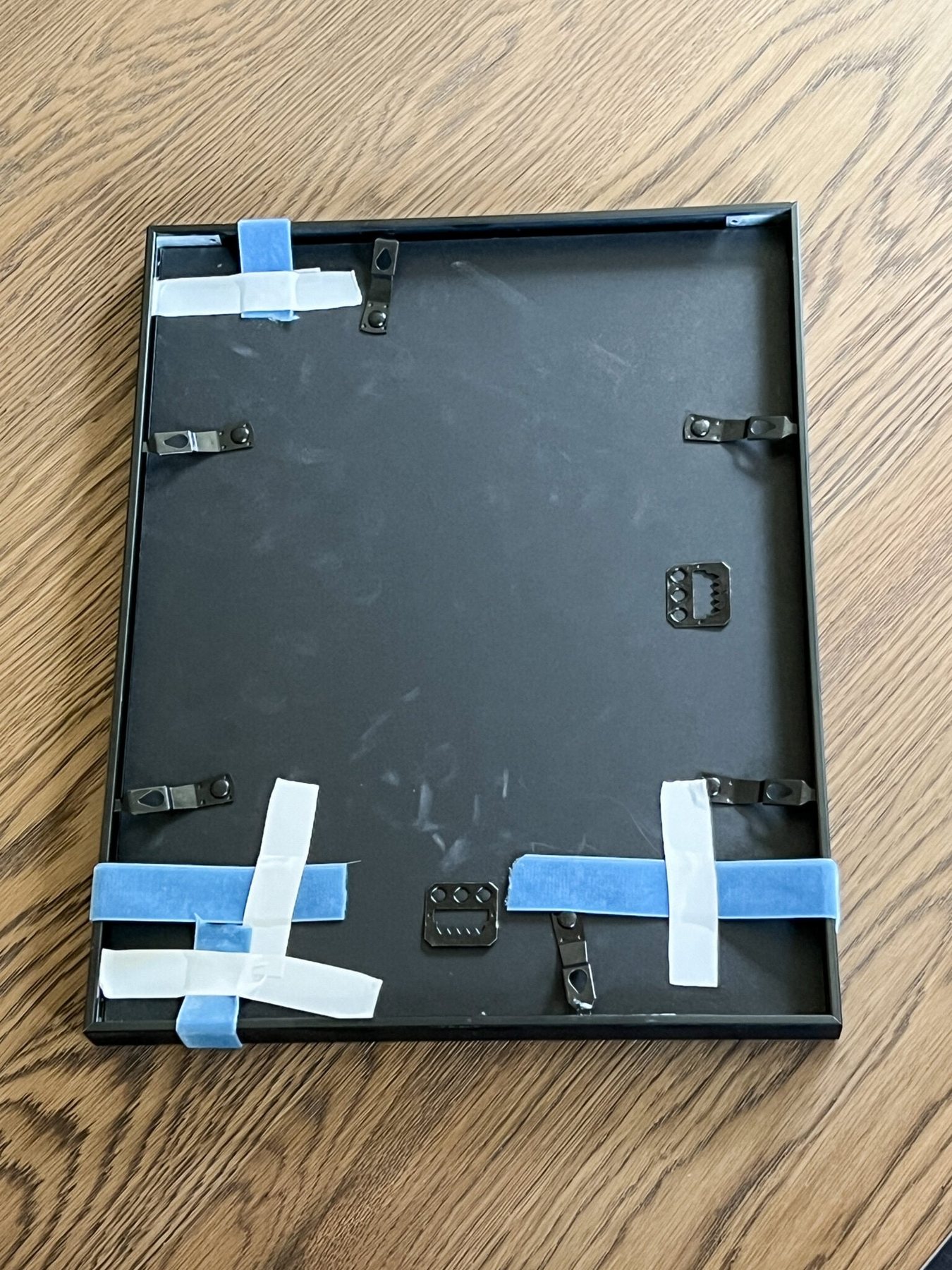 adding ribbon to picture frames using tape on the back
