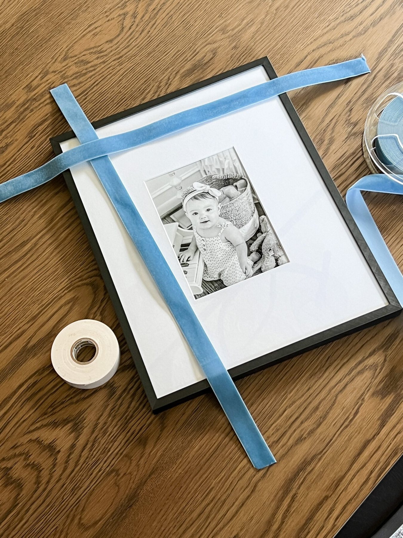 cutting ribbon to wrap around a picture frame