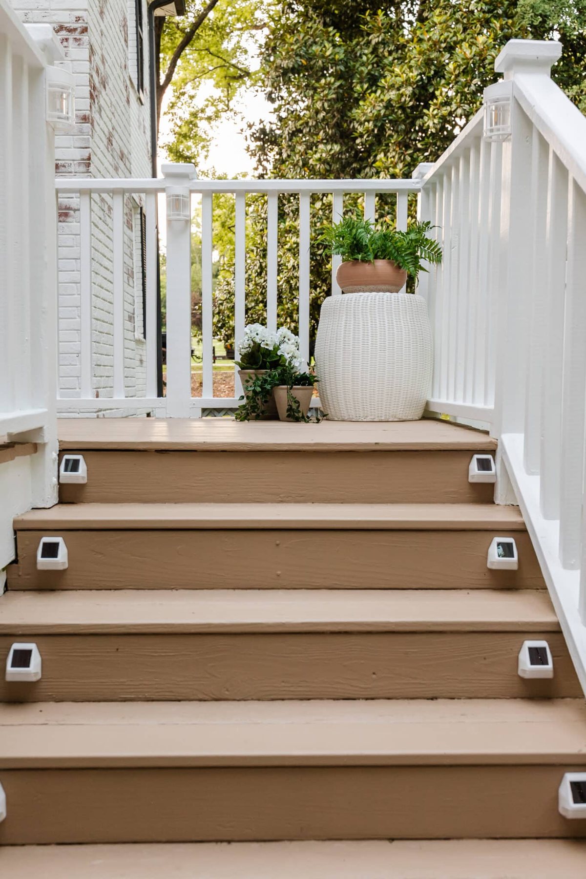 deck step solar lights on a deck with planters