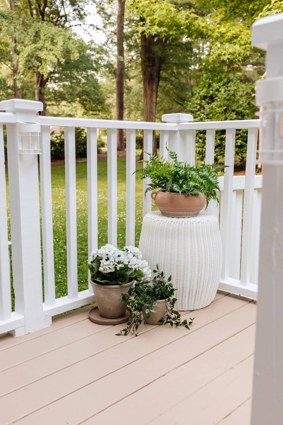 woven outdoor end table with planters on a deck