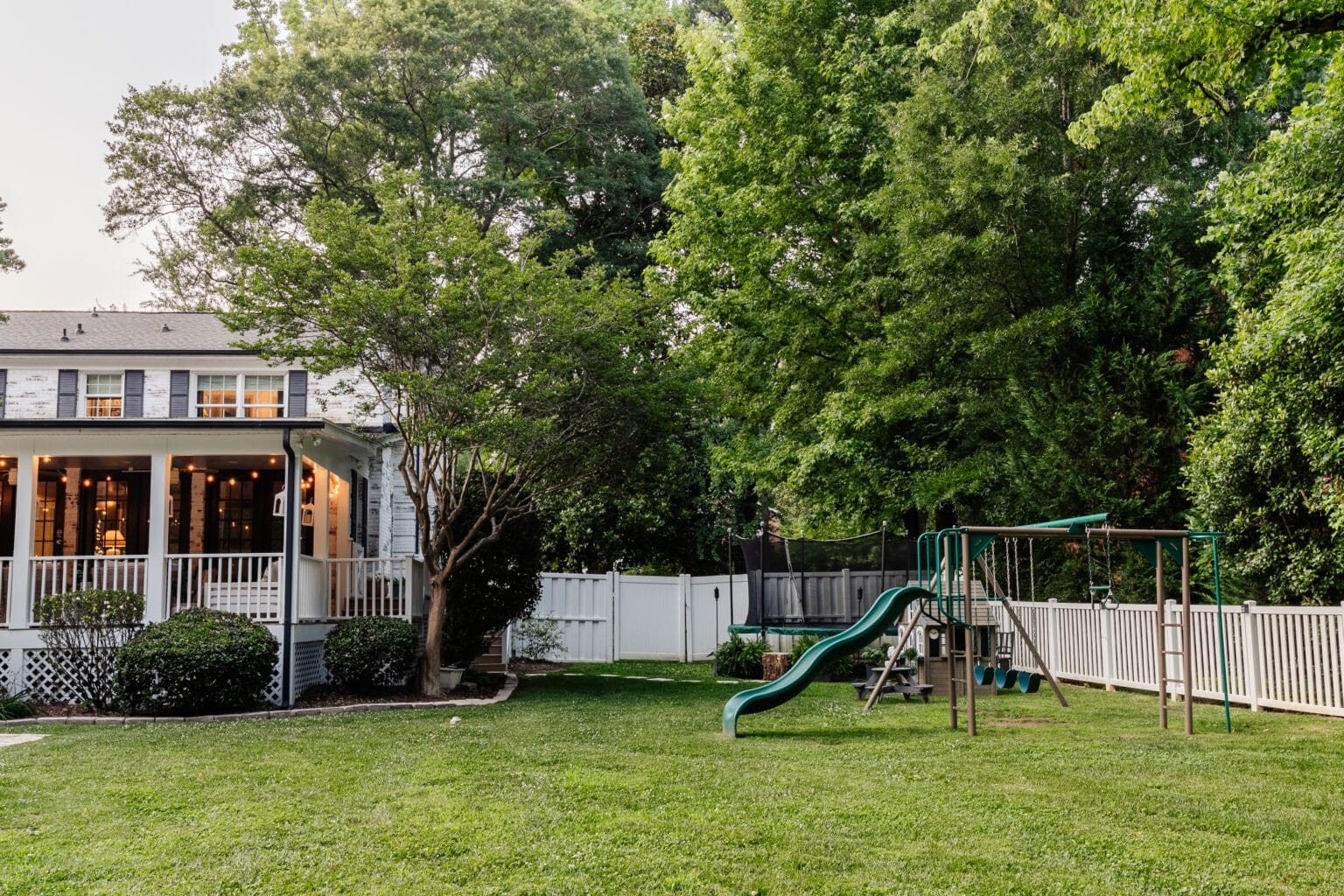 side yard play area with playground and trampoline