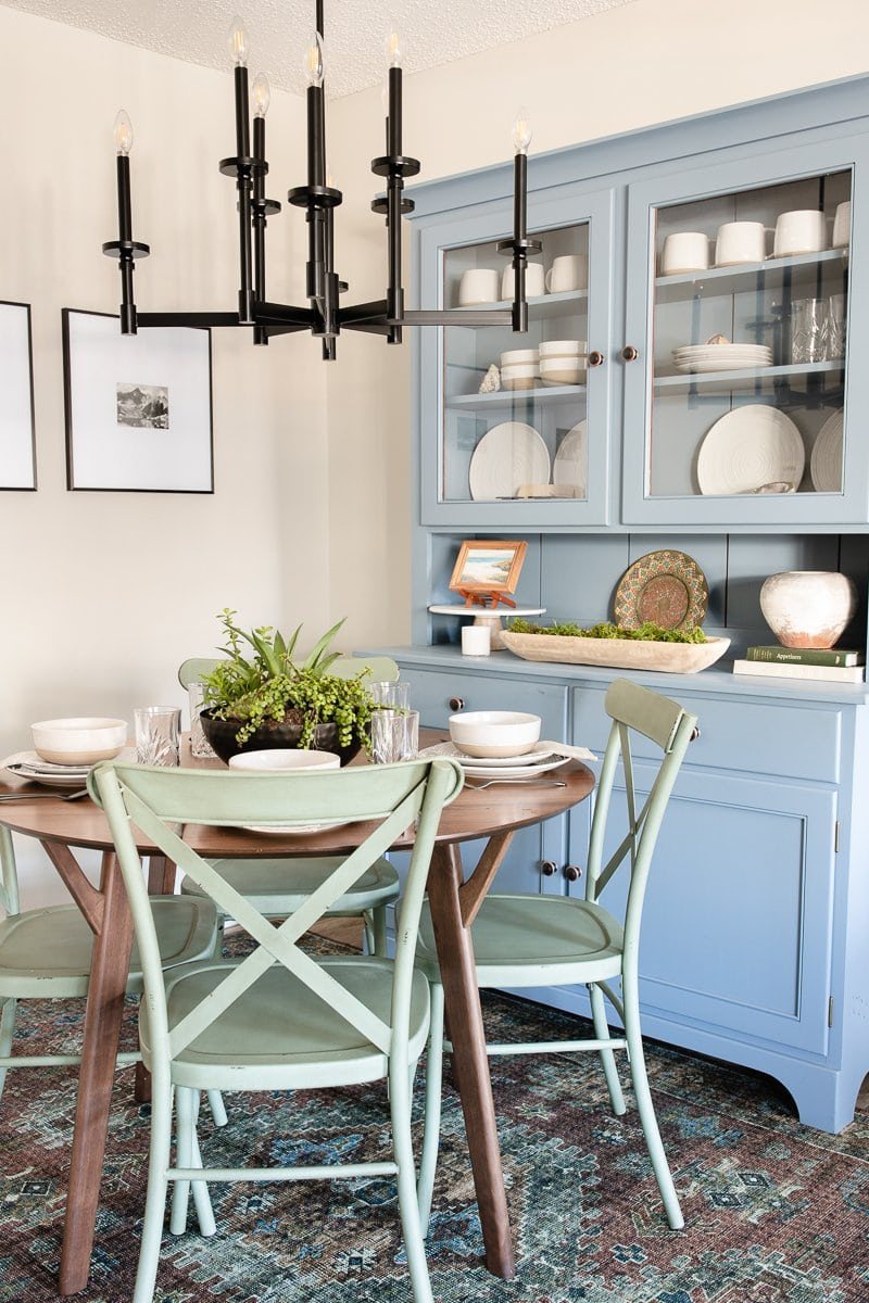 colorful dining room nook blue china cabinet green dining chairs