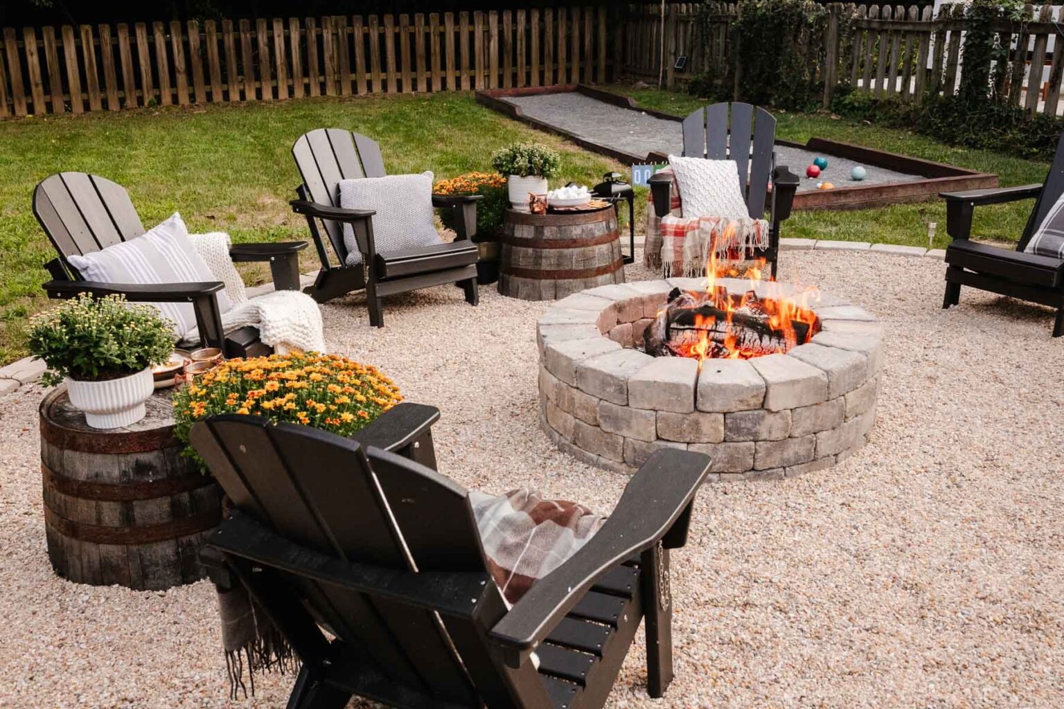 backyard fire pit with fall decor for a backyard party