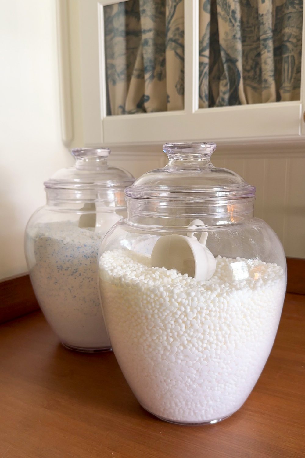 small laundry room organization - apothecary jars for detergent storage