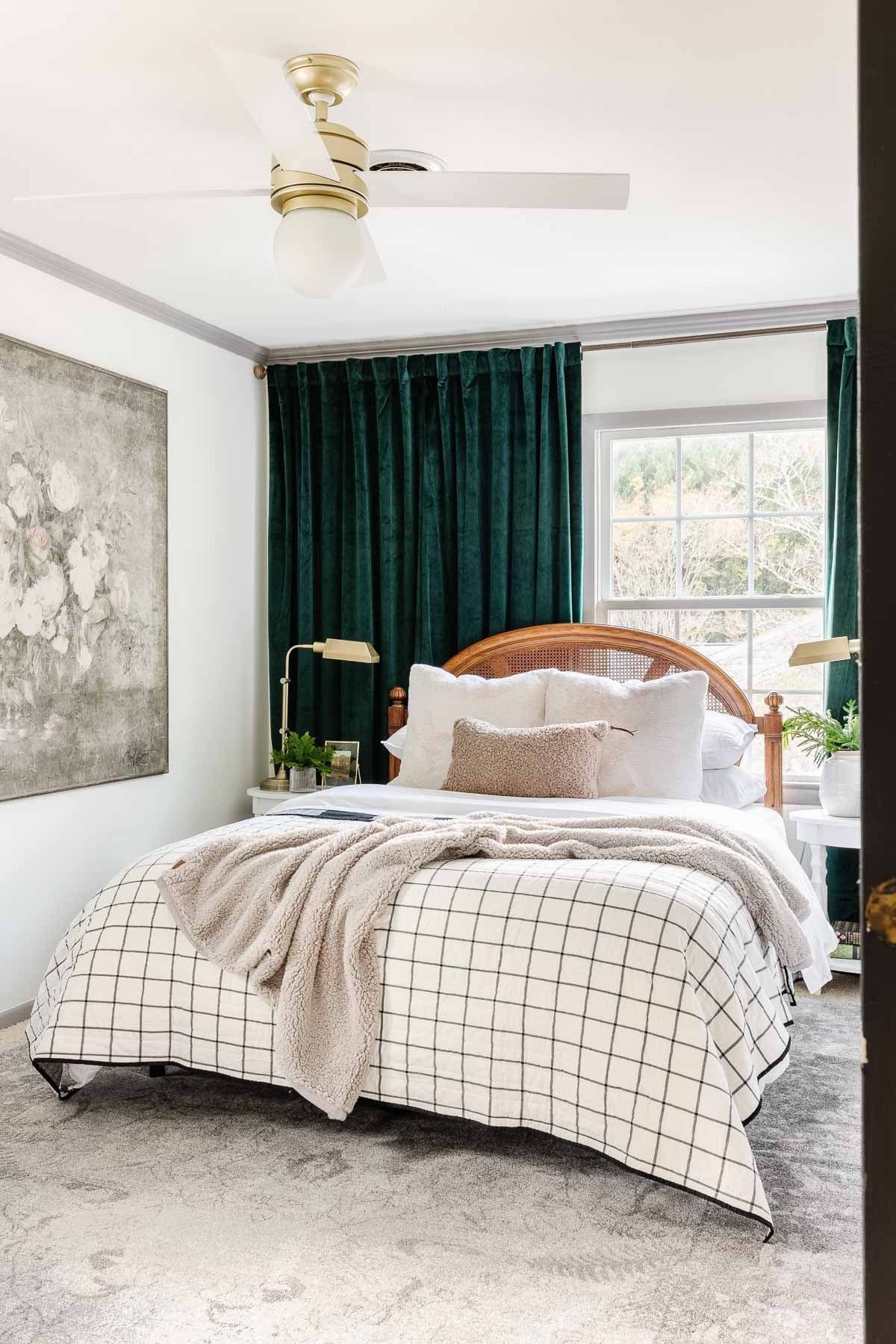 neutral winter bedding with green curtains