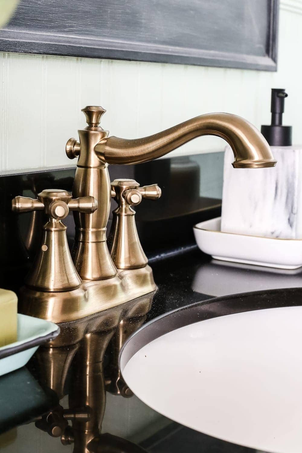 Aqua Meets Urban Powder Room Reveal | unigumushane.com - A dated powder room gets a modern meets traditional, urban meets farmhouse makeover with aquas, black and white, and antique brass.
