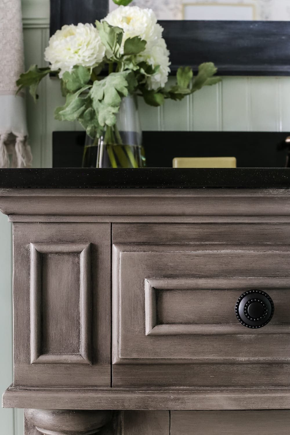 Weathered Gray Wood Look Vanity Makeover | unigumushane.com - A vanity gets a weathered gray wood look using just chalk paint and wax. Looks so much like real weathered wood in less time with less mess!