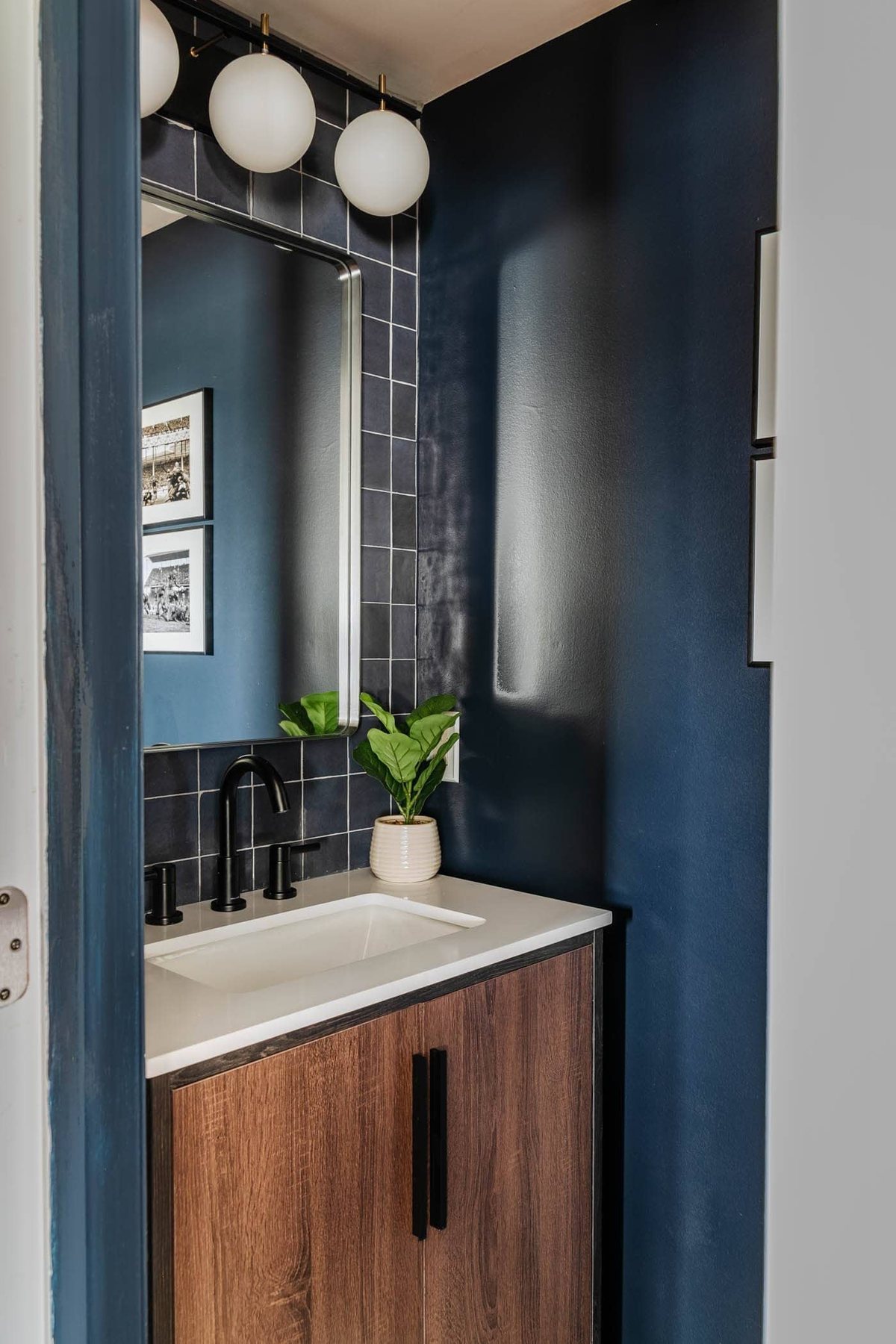 stacked tile focal wall behind a vanity in a small bathroom at a bachelor pad