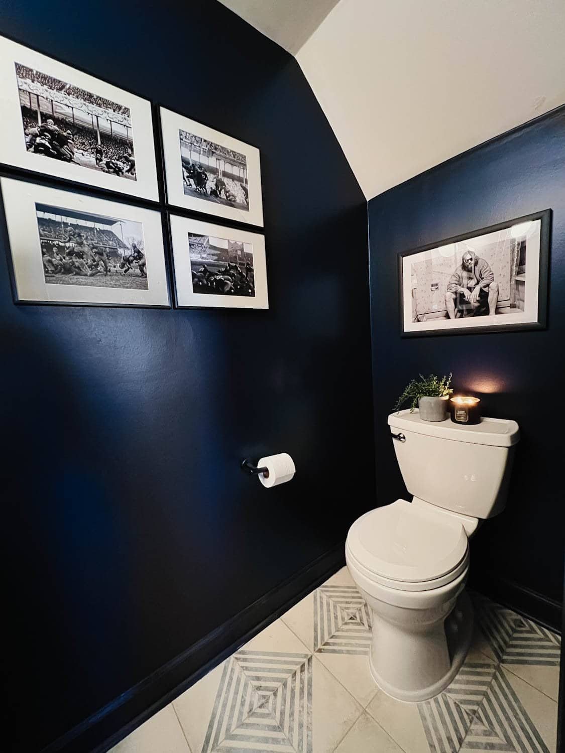 Benjamin Moore Polo Blue walls in a small powder room with masculine black and white art