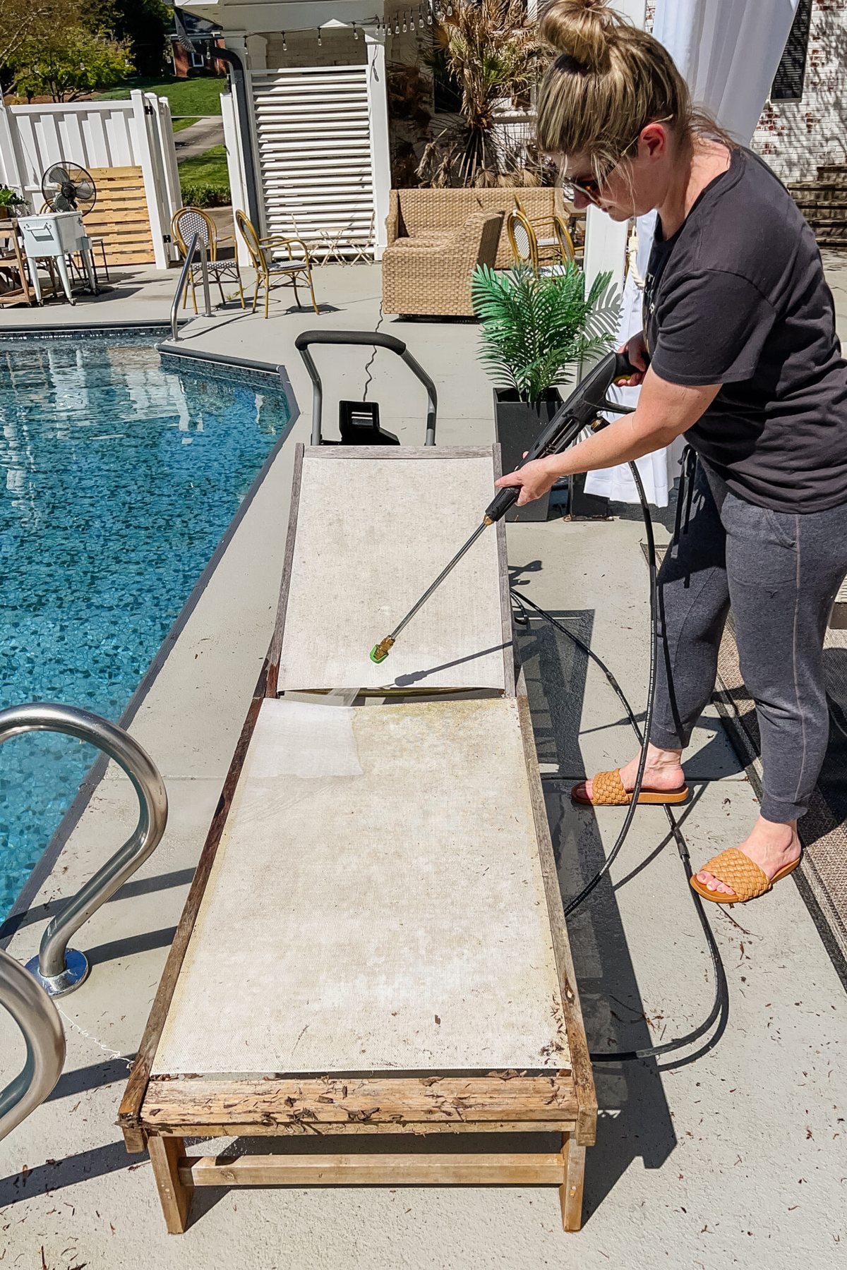 cleaning patio furniture with a pressure washer to remove mildew and dirt