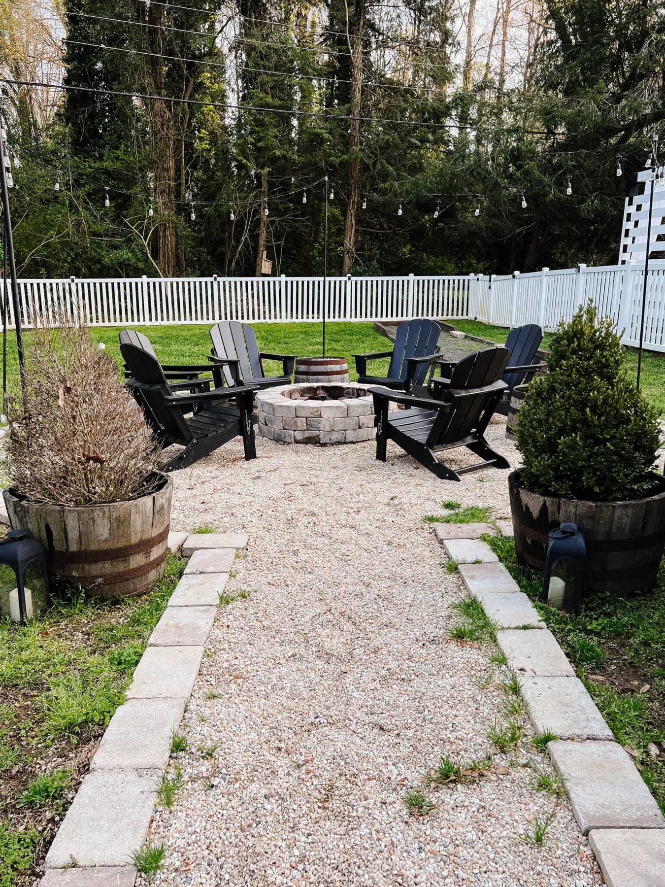 fire pit before spring cleaning with weeds and dead plants