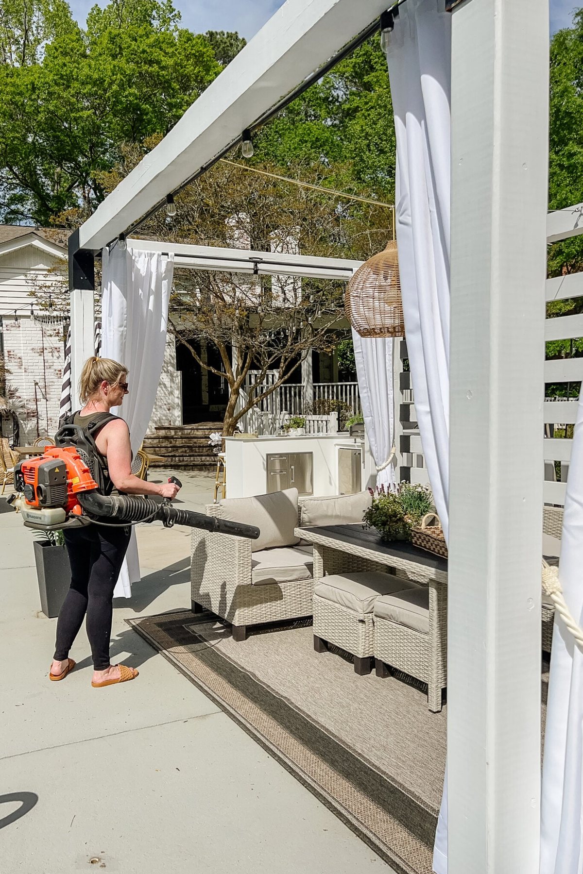 cleaning debris on a patio using a leaf blower