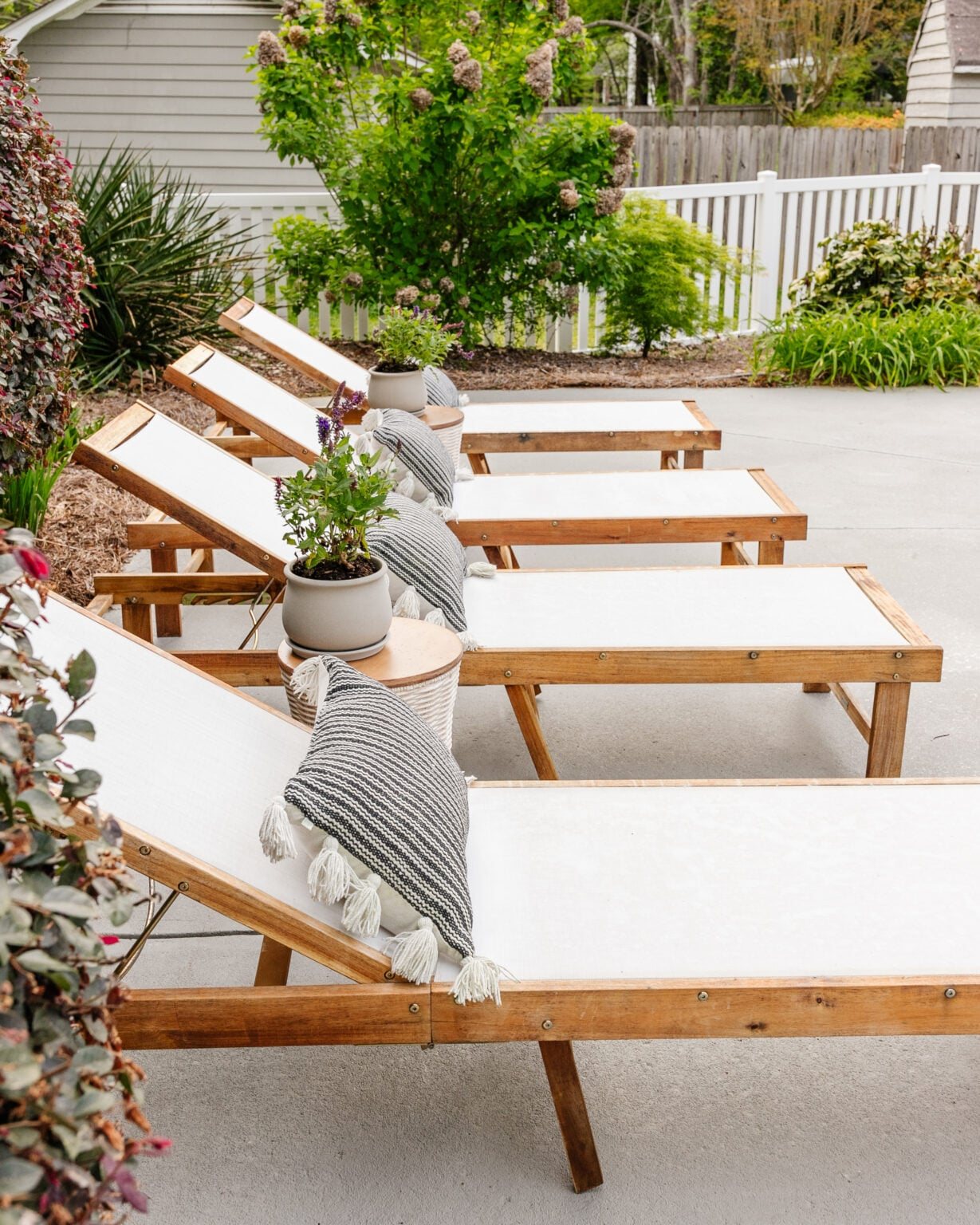 pool sun lounger chairs after spring cleaning with a pressure washer and teak oil